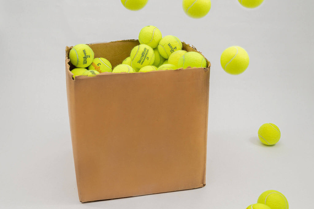 Used Tennis Balls in a Box Bouncing
